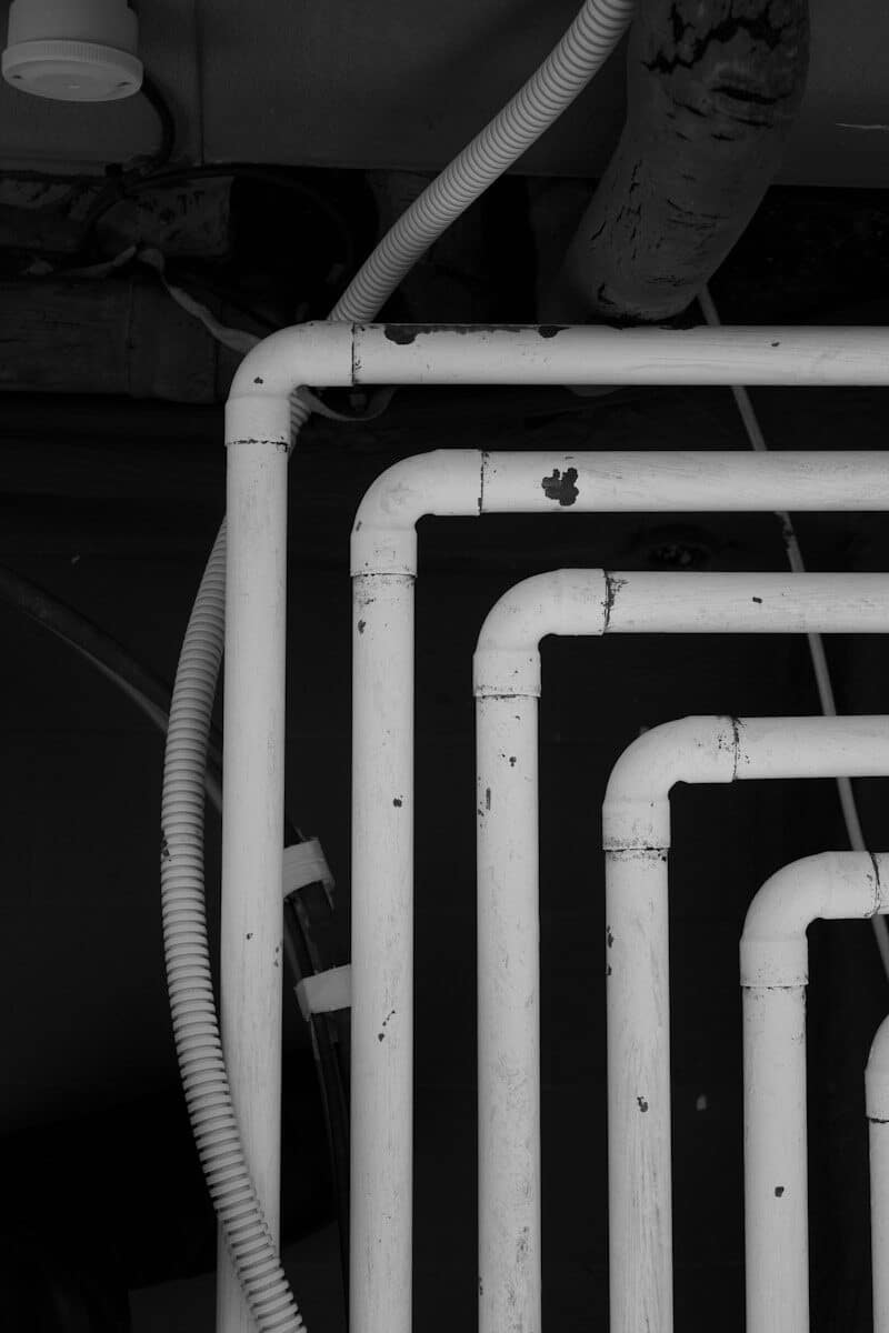white metal pipe in grayscale photography